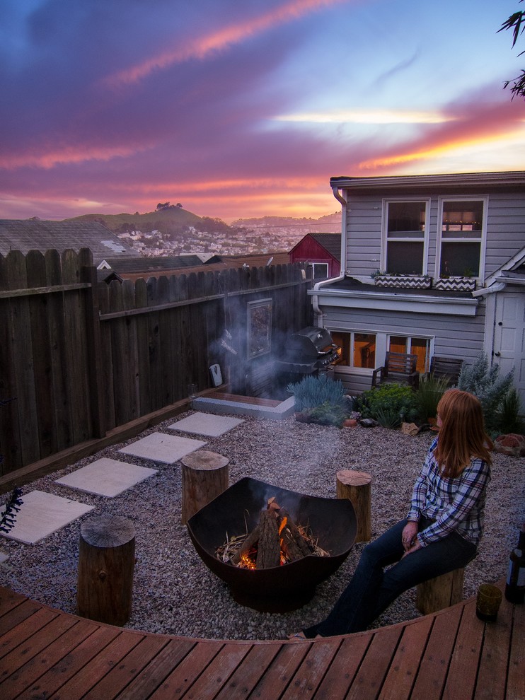 Inspiration for a small modern backyard full sun xeriscape in San Francisco with gravel and a fire feature.