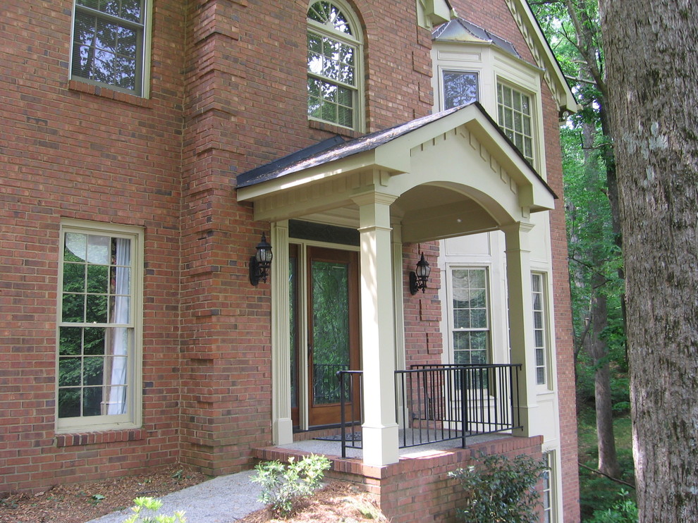 Inspiration for a mid-sized traditional front door in Atlanta with a single front door and a medium wood front door.