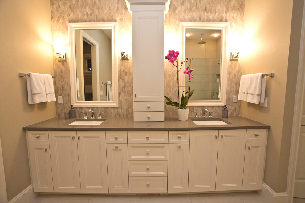 Photo of a large traditional master bathroom in Portland with shaker cabinets, white cabinets, a freestanding tub, a corner shower, gray tile, mosaic tile, beige walls, ceramic floors, an undermount sink and engineered quartz benchtops.