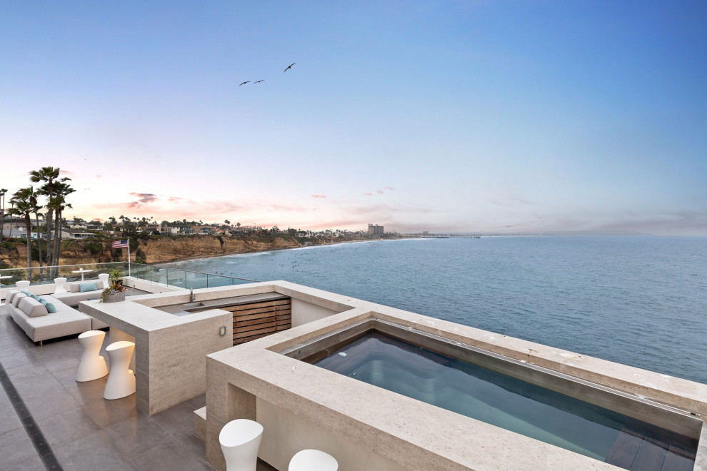 Design ideas for a small contemporary rooftop custom-shaped aboveground pool in San Diego with a hot tub and tile.