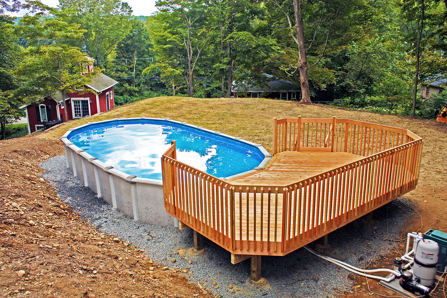 Mid-sized backyard round aboveground pool in New York.