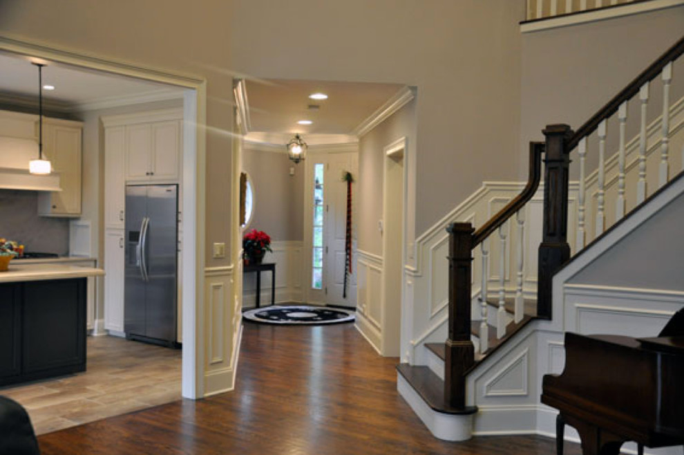 Photo of a large traditional hallway in Chicago with grey walls and dark hardwood floors.