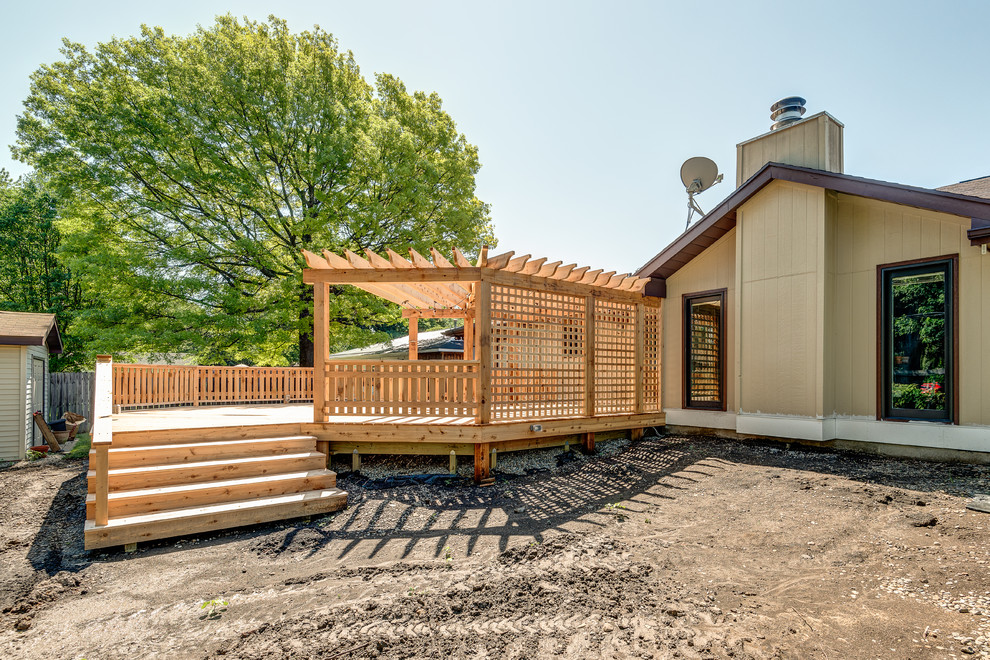 Inspiration for a large transitional backyard deck remodel in Chicago with a pergola