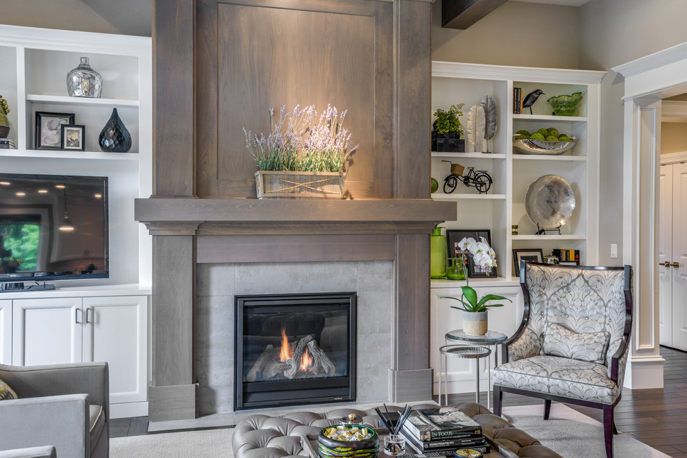 This is an example of a mid-sized transitional open concept living room in Portland with grey walls, dark hardwood floors, a standard fireplace, a tile fireplace surround and a freestanding tv.