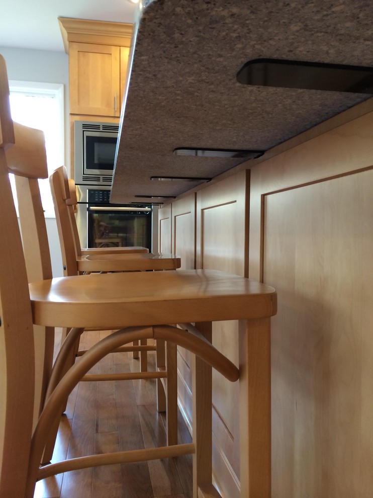 Example of a mid-sized transitional u-shaped light wood floor open concept kitchen design with an undermount sink, shaker cabinets, light wood cabinets, quartz countertops, stainless steel appliances and an island