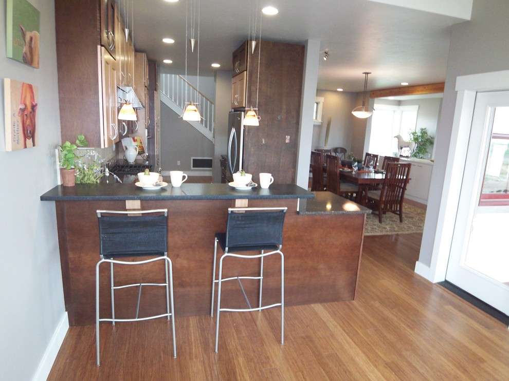 Example of a mid-sized transitional galley bamboo floor eat-in kitchen design with an undermount sink, shaker cabinets, dark wood cabinets, quartz countertops, beige backsplash, ceramic backsplash, stainless steel appliances and a peninsula