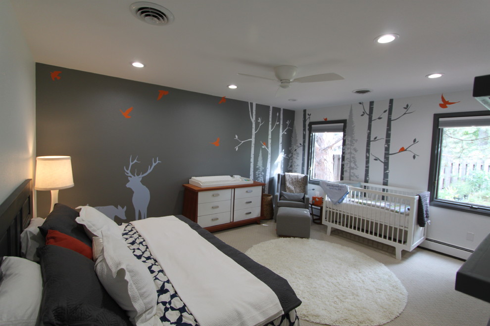 This is an example of a contemporary nursery for boys in Denver with carpet.