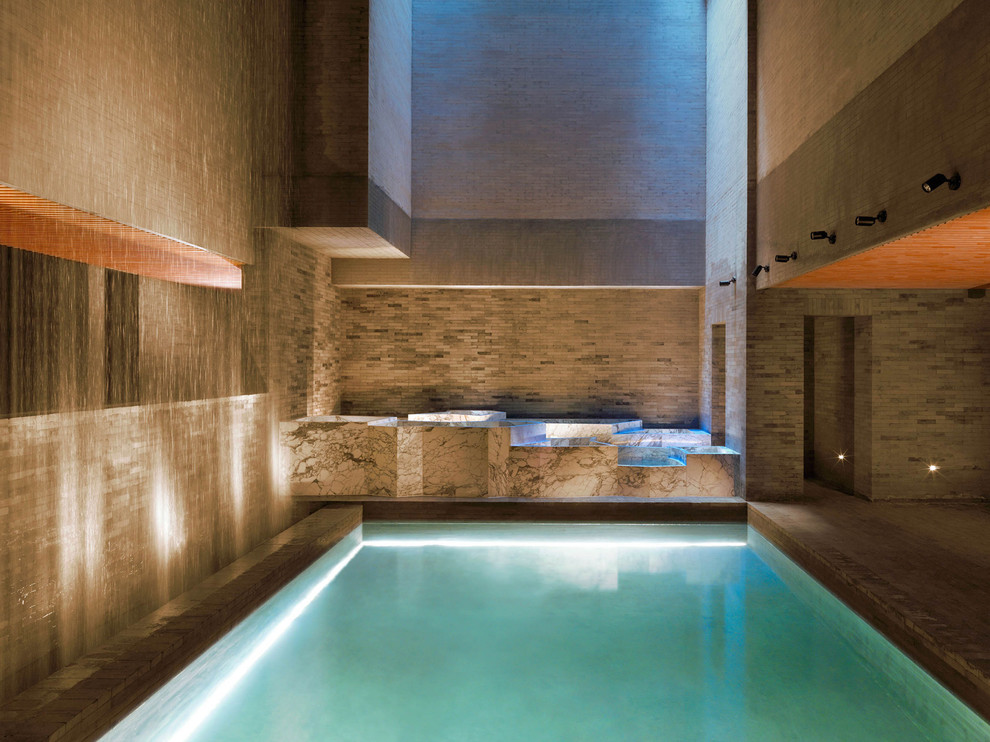 Design ideas for a mid-sized asian indoor rectangular pool in New York with a water feature.