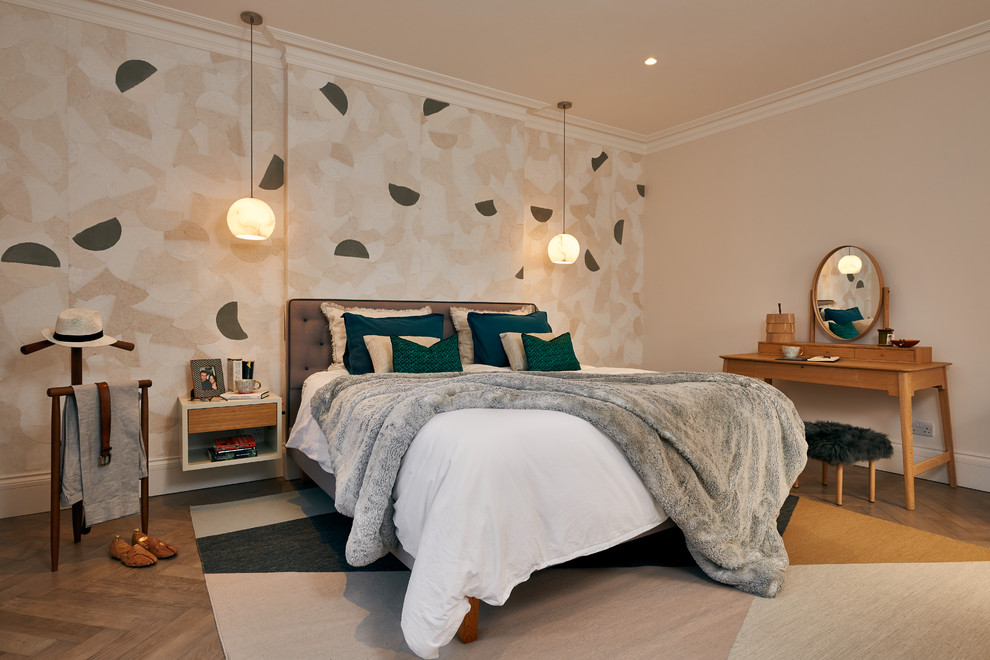 Medium sized contemporary master bedroom in London with medium hardwood flooring, white walls and no fireplace.