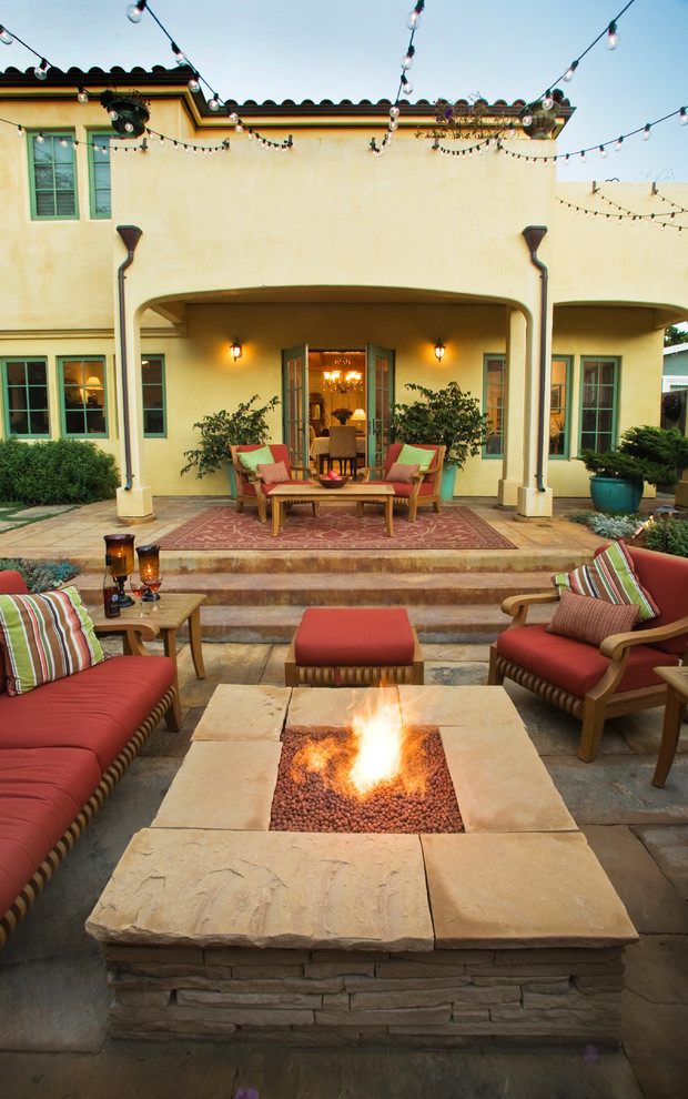 Large mediterranean backyard patio in San Francisco with a fire feature, natural stone pavers and no cover.