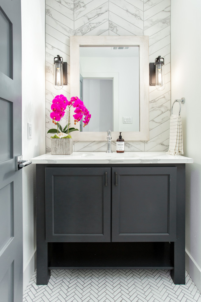 Mid-sized beach style powder room in Dallas with shaker cabinets, grey cabinets, white walls, an undermount sink, white floor and white benchtops.