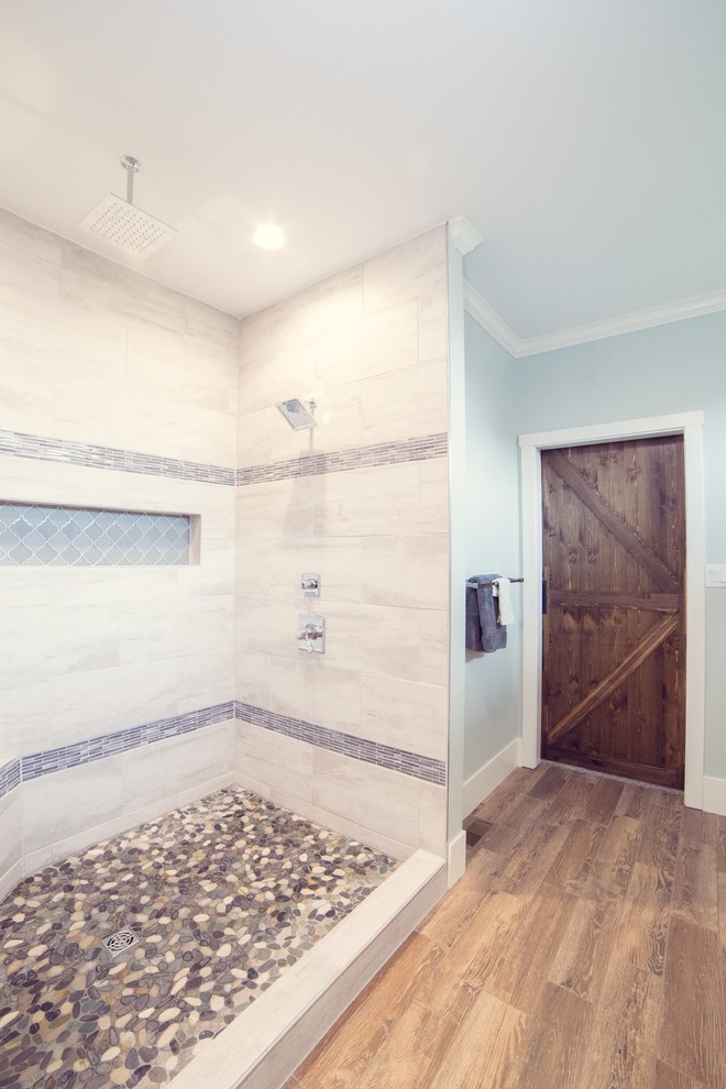 Inspiration for a country master bathroom in Cedar Rapids with recessed-panel cabinets, white cabinets, an open shower, a two-piece toilet, beige tile, porcelain tile, green walls, porcelain floors, an integrated sink, brown floor, an open shower and white benchtops.
