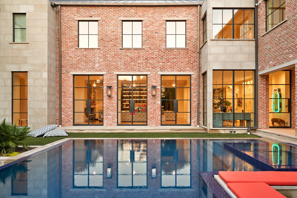 Beverly | 2018 - Example of a large transitional brown two-story brick gable roof design in Dallas with a metal roof