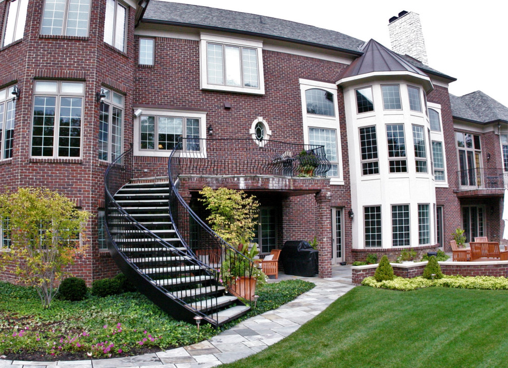 Design ideas for a large traditional slate curved staircase in Detroit with metal risers and metal railing.