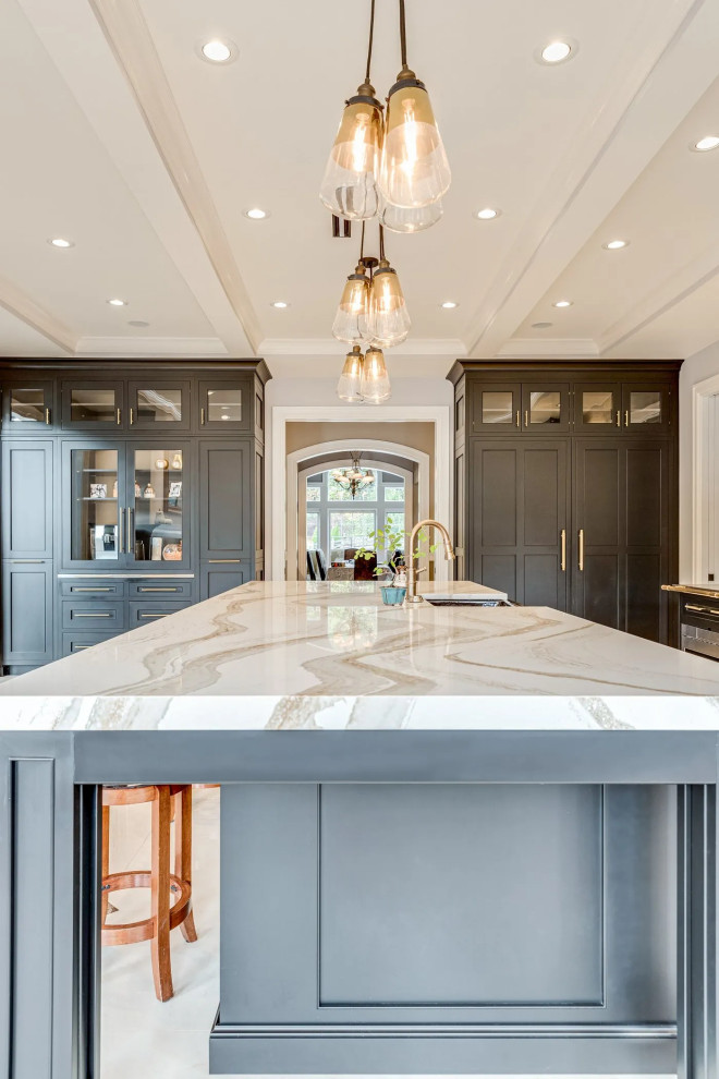 Transitional beige floor kitchen photo in Baltimore with black cabinets, beige backsplash, an island and beige countertops