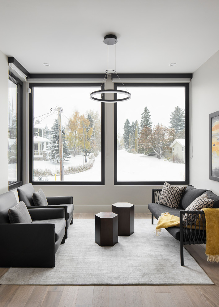 Large minimalist l-shaped light wood floor kitchen photo in Calgary with a double-bowl sink, flat-panel cabinets, quartz countertops, quartz backsplash and an island