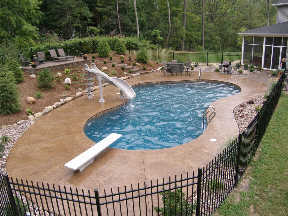 Inspiration for a large arts and crafts backyard custom-shaped natural pool in New York with a water slide and brick pavers.
