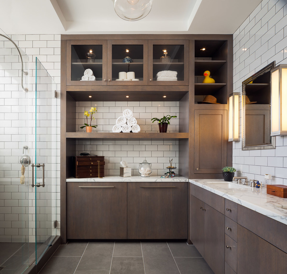 Transitional master bathroom in San Francisco with marble benchtops, flat-panel cabinets, dark wood cabinets, white tile, subway tile, white walls, an undermount sink and a hinged shower door.