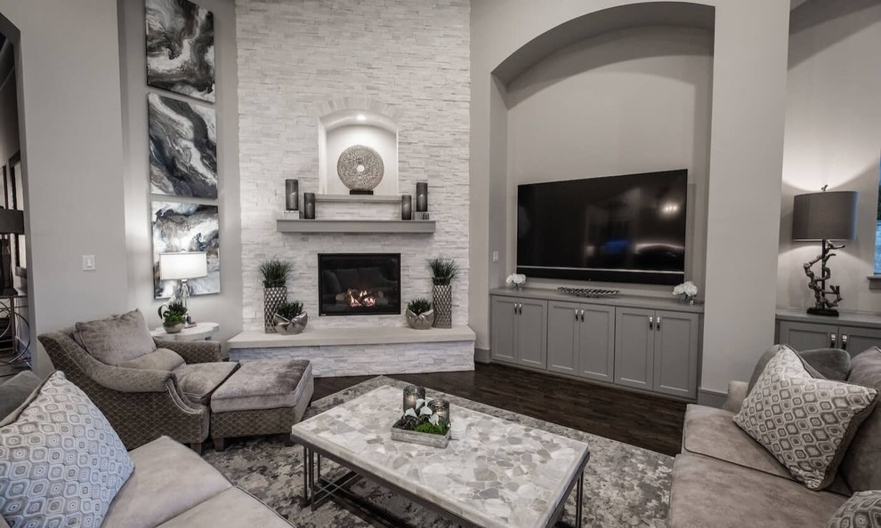Transitional open concept living room in Dallas with grey walls, dark hardwood floors, a built-in media wall, brown floor, a corner fireplace and a stone fireplace surround.
