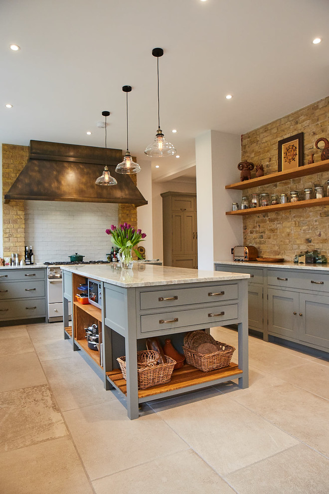 This is an example of a large country u-shaped eat-in kitchen in Other with a farmhouse sink, beaded inset cabinets, grey cabinets, granite benchtops, beige splashback, subway tile splashback, coloured appliances, ceramic floors, with island, beige floor and beige benchtop.