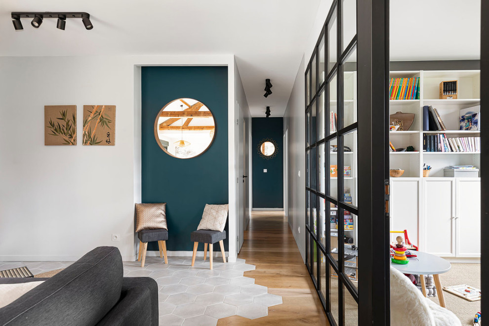This is an example of a small contemporary foyer in Lyon with blue walls and terra-cotta floors.