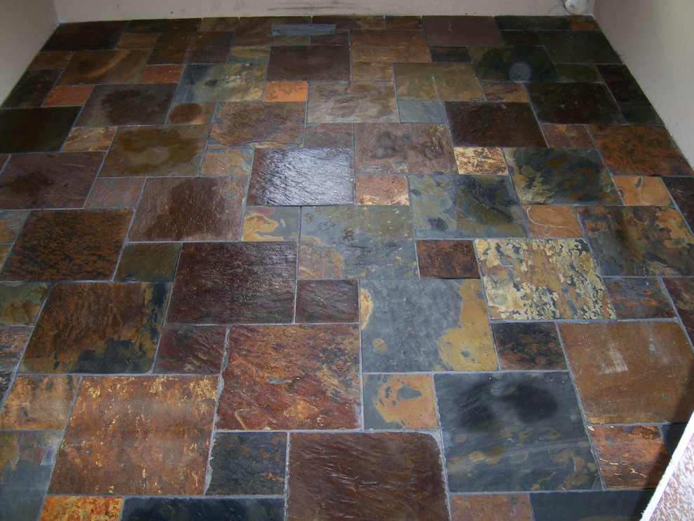 Example of a mountain style master multicolored tile and stone tile slate floor bathroom design