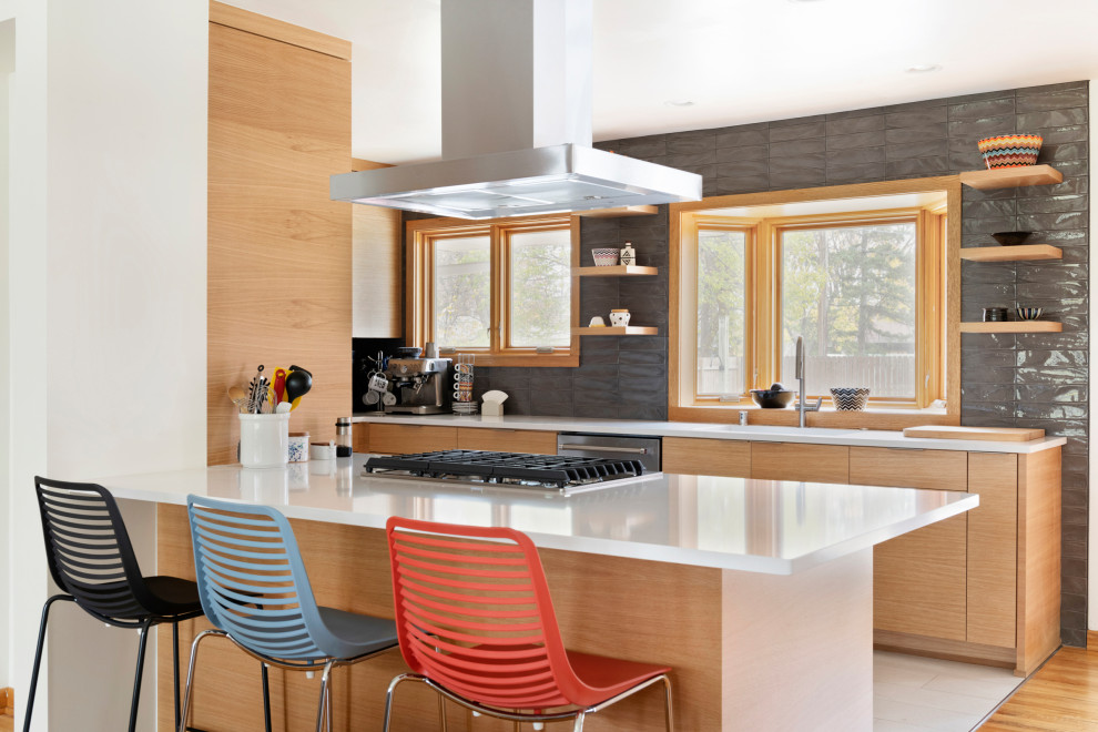 Small midcentury galley eat-in kitchen in Minneapolis with an undermount sink, flat-panel cabinets, light wood cabinets, quartzite benchtops, grey splashback, subway tile splashback, stainless steel appliances, porcelain floors, with island, grey floor and white benchtop.