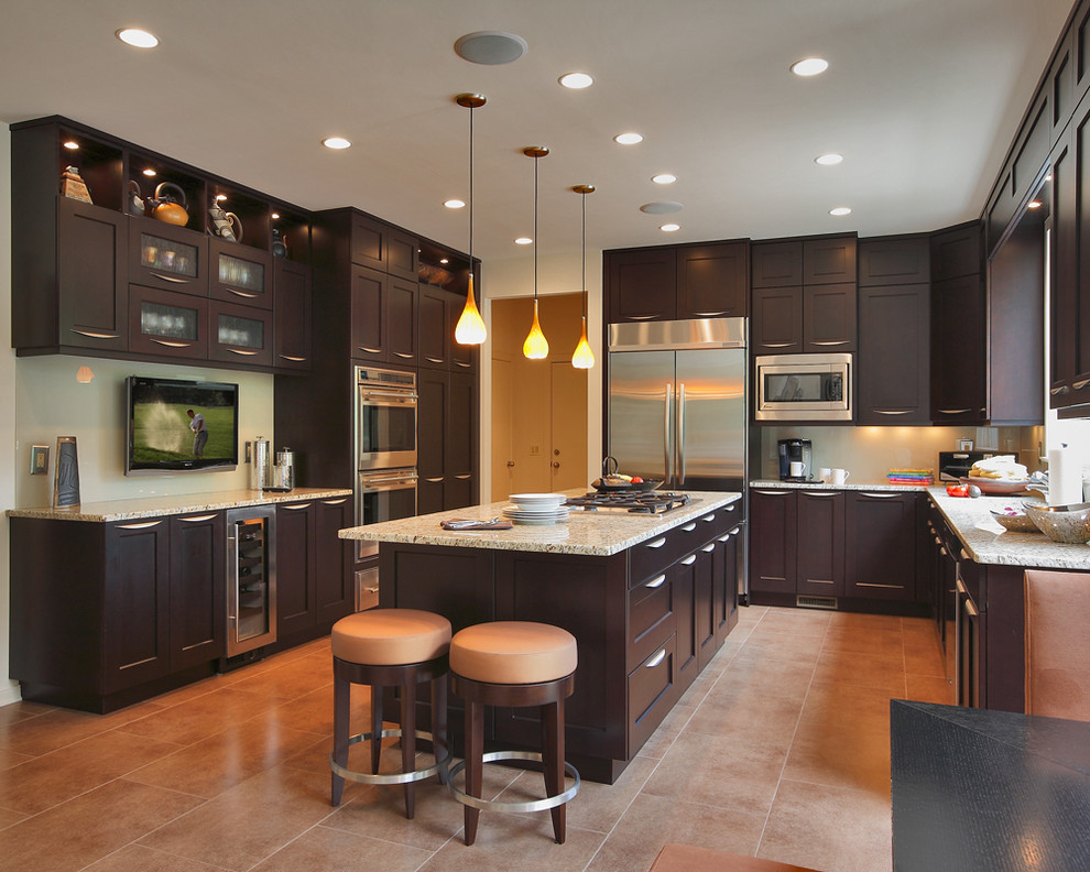 Design ideas for a large transitional u-shaped eat-in kitchen in DC Metro with an undermount sink, recessed-panel cabinets, dark wood cabinets, granite benchtops, stainless steel appliances, ceramic floors and with island.