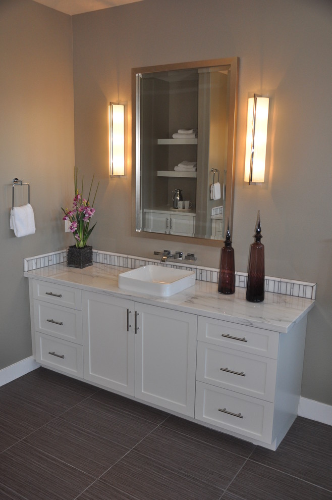 Photo of a mid-sized modern master bathroom in Los Angeles with shaker cabinets, white cabinets, white tile, ceramic tile, grey walls, vinyl floors, a vessel sink and marble benchtops.