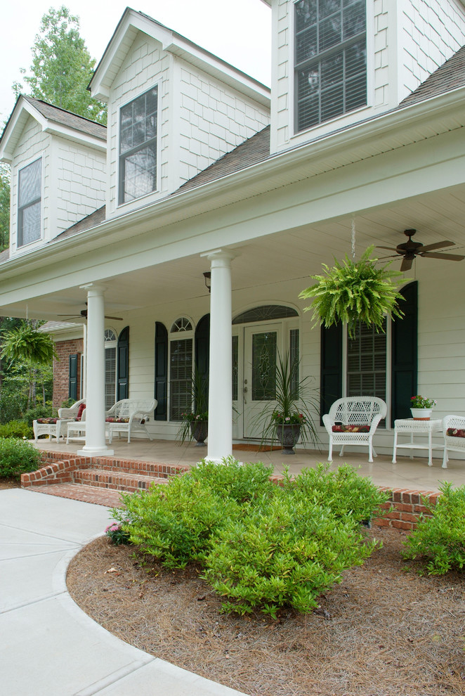 Design ideas for a traditional front yard verandah in Charlotte with a roof extension.