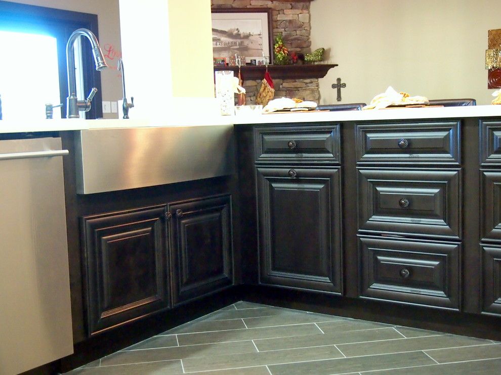 Open concept kitchen - large transitional vinyl floor and brown floor open concept kitchen idea in Phoenix with a farmhouse sink, raised-panel cabinets, white cabinets, solid surface countertops, brown backsplash, matchstick tile backsplash, stainless steel appliances and an island