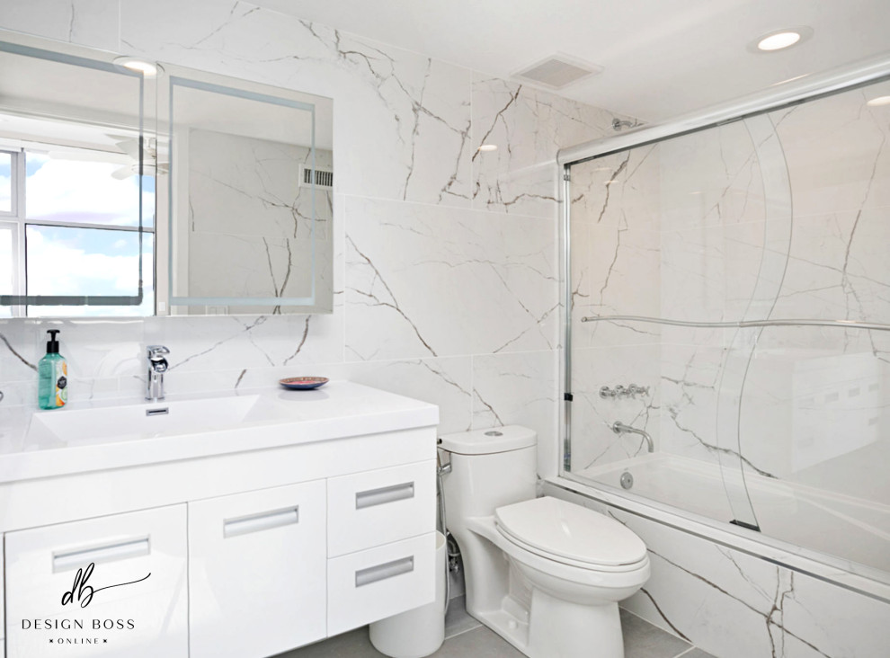 Inspiration for a small contemporary master bathroom in San Diego with white cabinets, a shower/bathtub combo, white tile, white walls, concrete floors, grey floor, a sliding shower screen, white benchtops, a single vanity and a floating vanity.
