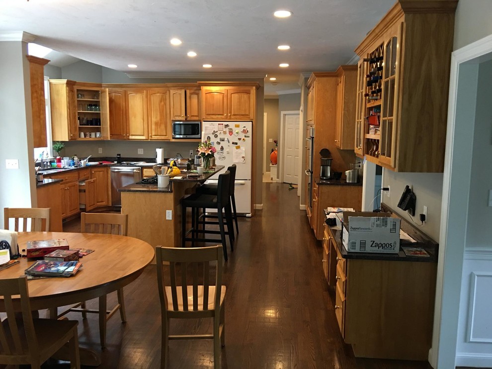 Inspiration for a large traditional l-shaped eat-in kitchen in Boston with shaker cabinets, white cabinets, soapstone benchtops and with island.