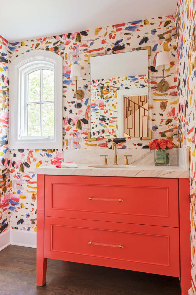 Inspiration for a mid-sized transitional powder room in Other with orange cabinets, multi-coloured walls, an undermount sink, marble benchtops, brown floor, recessed-panel cabinets, dark hardwood floors and white benchtops.