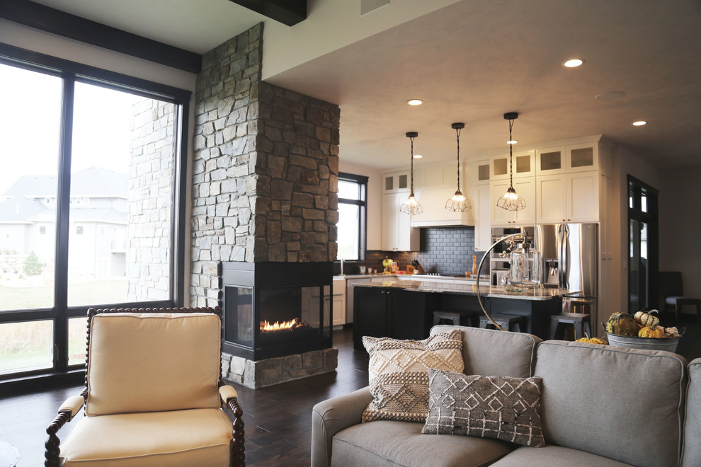 Inspiration for a mid-sized country open concept living room in Other with white walls, dark hardwood floors, a two-sided fireplace, a stone fireplace surround and a wall-mounted tv.