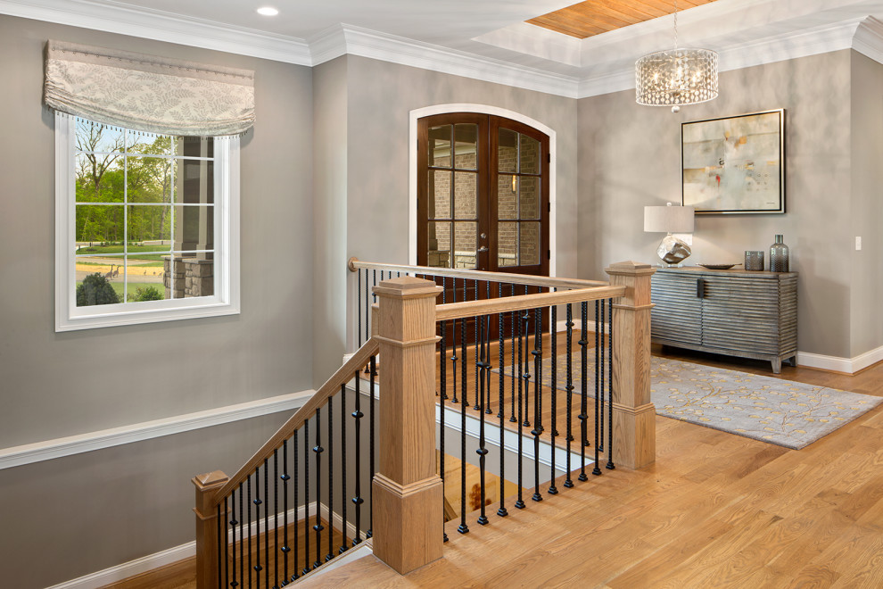Foyer - large transitional medium tone wood floor and beige floor foyer idea in Cincinnati with gray walls and a medium wood front door