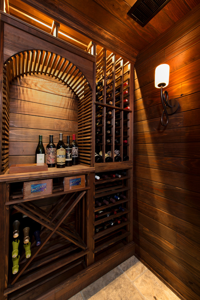 Design ideas for a small country wine cellar in Other with travertine floors, diamond bins and beige floor.
