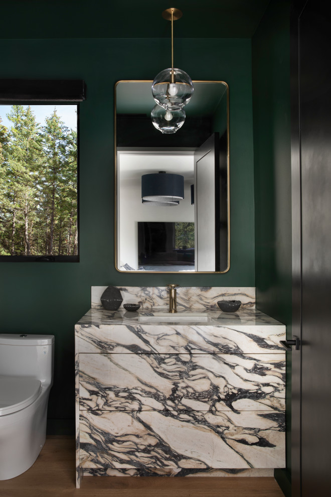 Bathroom - rustic medium tone wood floor, brown floor and single-sink bathroom idea with flat-panel cabinets, green walls, an undermount sink, multicolored countertops and a built-in vanity