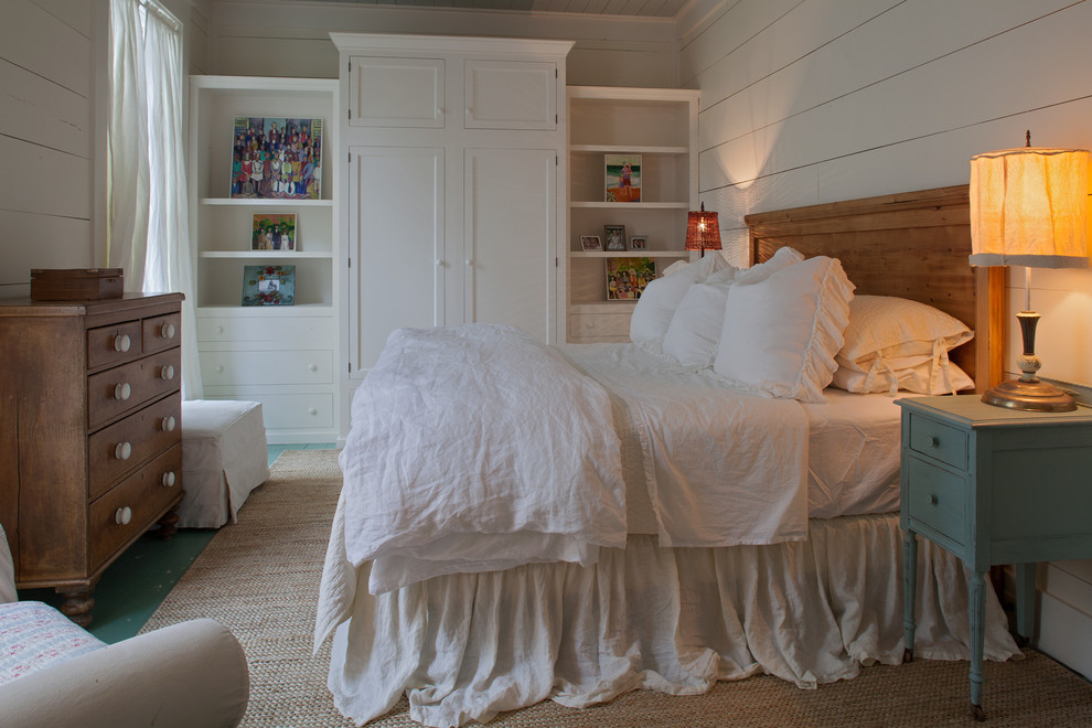Design ideas for a traditional master bedroom in Miami with white walls and painted wood floors.