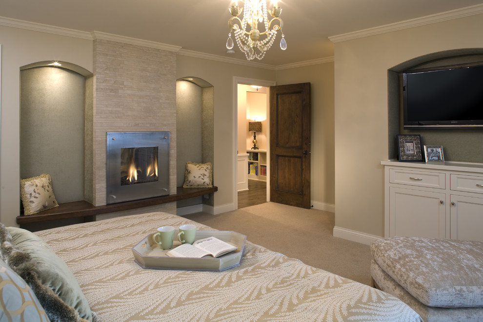 Large contemporary master bedroom in Minneapolis with a tile fireplace surround, carpet and a standard fireplace.