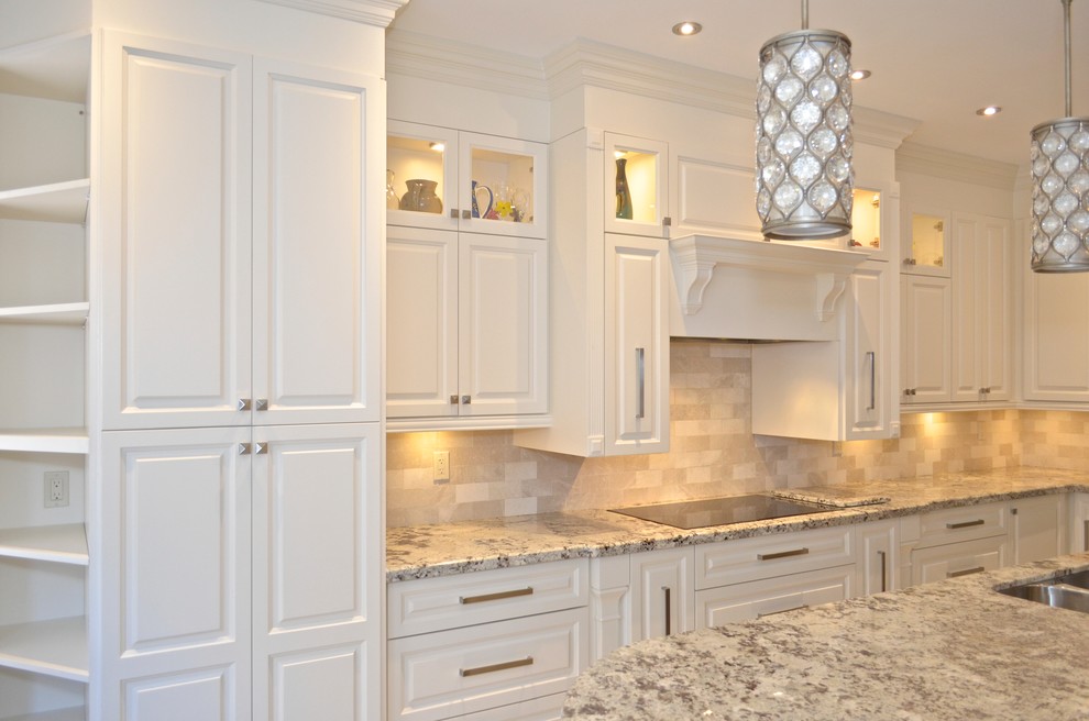 Enclosed kitchen - mid-sized craftsman l-shaped enclosed kitchen idea in Toronto with an undermount sink, raised-panel cabinets, white cabinets, granite countertops, beige backsplash, stainless steel appliances and an island