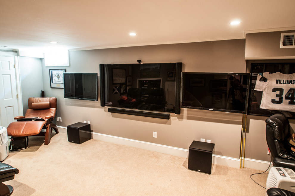 Photo of a small contemporary home theatre in Charlotte with a wall-mounted tv, beige walls and carpet.