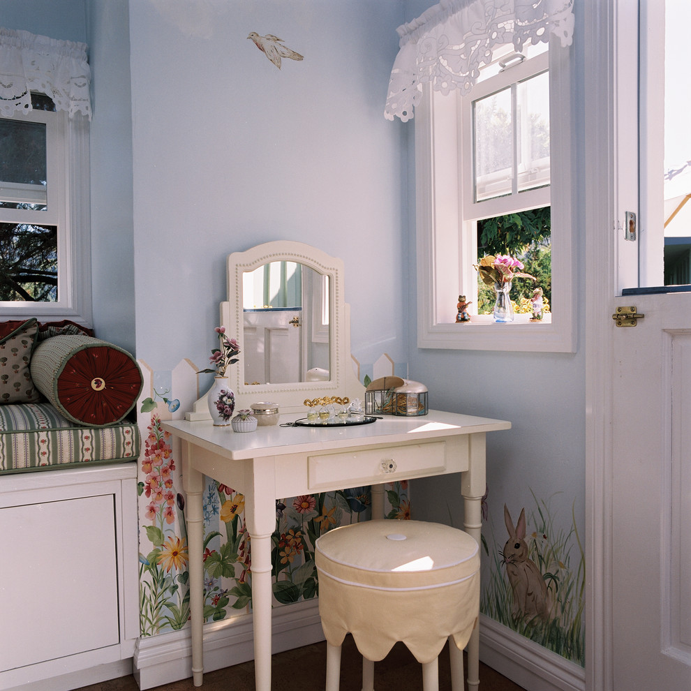 This is an example of a mid-sized traditional gender-neutral kids' playroom for kids 4-10 years old in San Francisco with blue walls and cork floors.