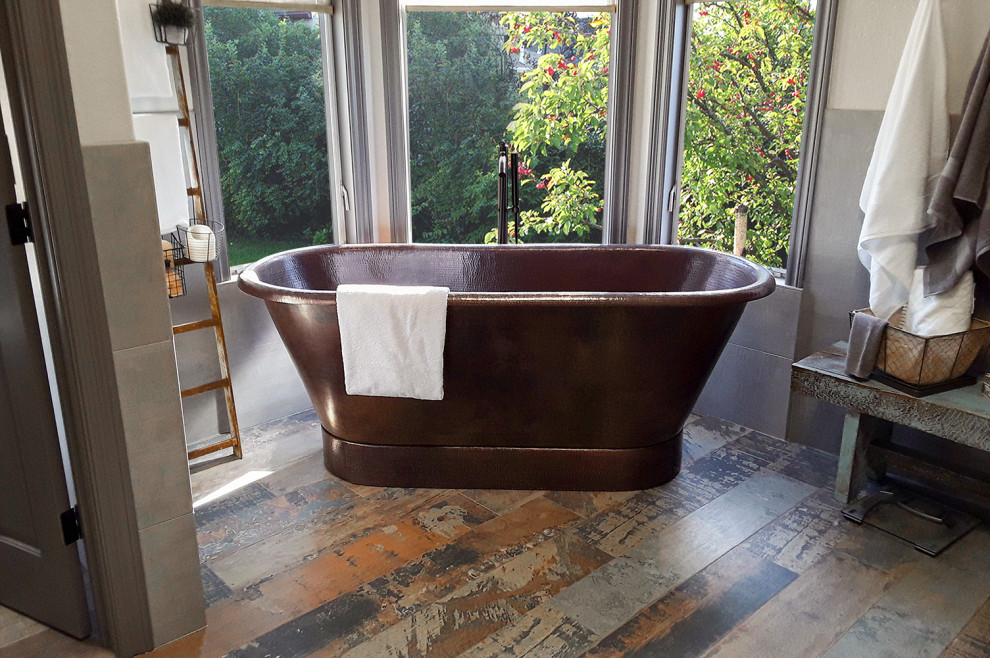 Photo of a midcentury bathroom in Phoenix with a freestanding tub.