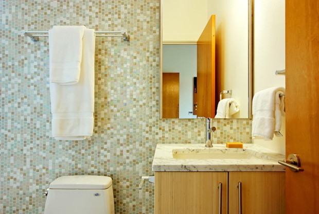 This is an example of a mid-sized modern 3/4 bathroom in Wilmington with flat-panel cabinets, light wood cabinets, a one-piece toilet, blue tile, green tile, white tile, glass sheet wall, multi-coloured walls, an undermount sink and marble benchtops.