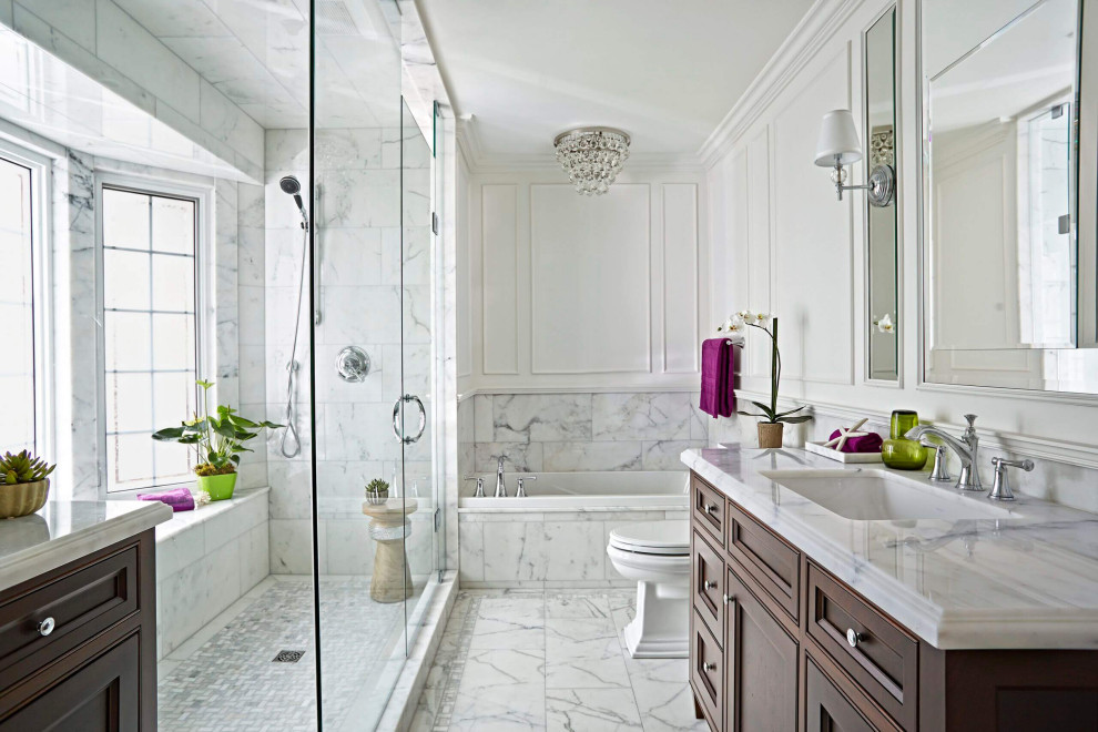 This is an example of a traditional bathroom in Delhi with beaded inset cabinets, dark wood cabinets, a drop-in tub, a corner shower, white tile, white walls, an undermount sink, white floor, a hinged shower door, white benchtops, a single vanity, a freestanding vanity and panelled walls.