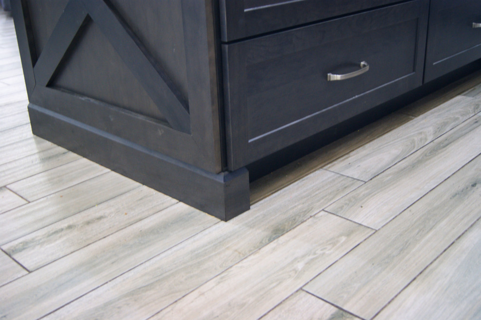 Inspiration for a mid-sized modern l-shaped porcelain tile and gray floor open concept kitchen remodel in Phoenix with an undermount sink, shaker cabinets, brown cabinets, granite countertops, white backsplash, subway tile backsplash, stainless steel appliances, an island and white countertops
