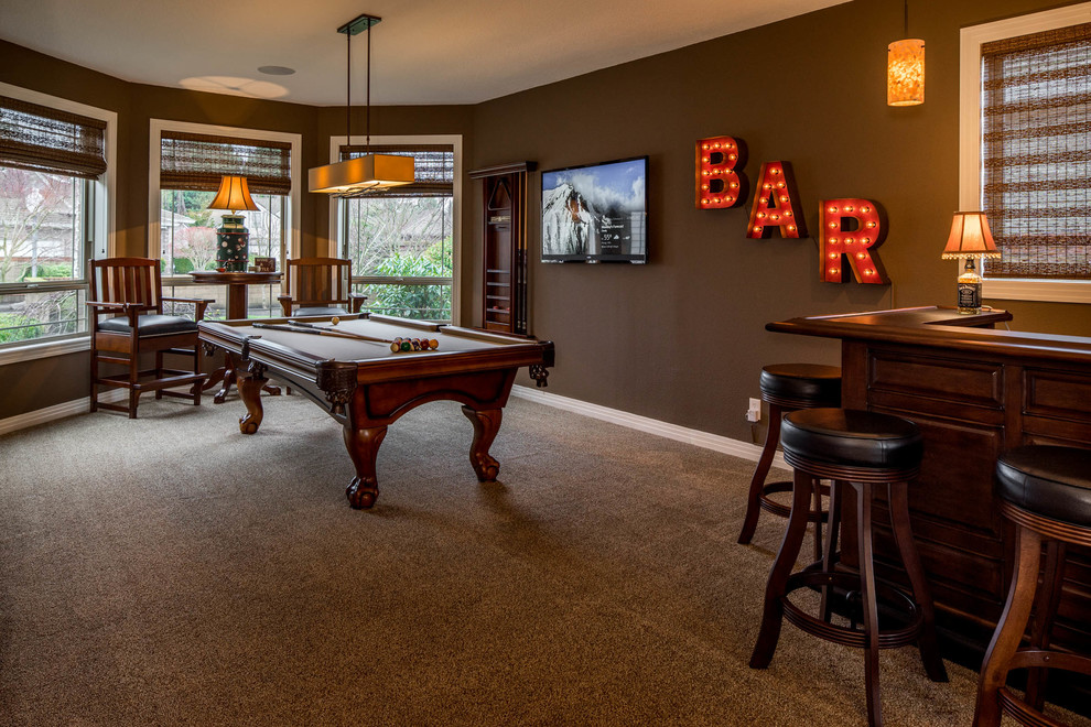 Photo of a large traditional seated home bar in Portland with carpet, raised-panel cabinets, dark wood cabinets, wood benchtops and brown benchtop.
