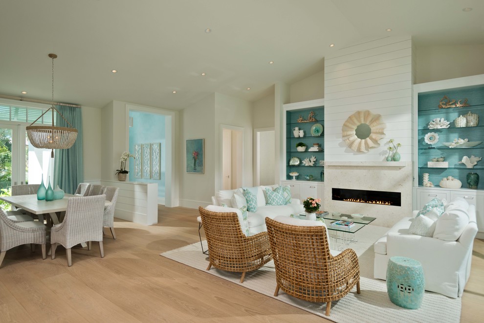 Beach style formal open concept living room in Miami with beige walls, light hardwood floors, a ribbon fireplace, a stone fireplace surround, no tv and beige floor.