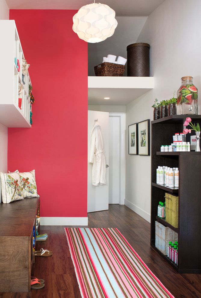 Small modern entryway in Denver with pink walls and dark hardwood floors.